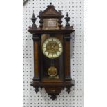 An early 20th century Vienna regulator style wall clock, with floral decorated architectural case,