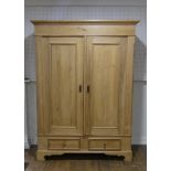 An antique pine double Wardrobe, with panel doors and two drawers, on bracket feet, W:148cm x H: