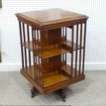 An Edwardian mahogany Revolving Bookcase, of two tier four section form, raised on an X framed base,