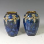 A pair of Doulton Lambeth stoneware Vases, with floral swag decoration on a mottled blue ground,