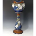 A Royal Doulton stoneware Jardiniere and Stand, decorated with tubelined roses on a blue ground,