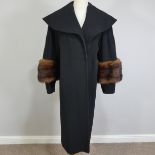 Vintage Fashion, circa 1950s; a black woollen Opera Coat, with mink fur trimmed sleeves, together