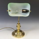 A vintage 20thC desk Lamp, having a brass base with green glass rectangular shade, H 37cm.