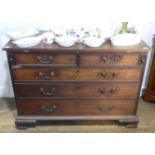 A Georgian mahogany Chest of Drawers, the rectangular fold-over top above two short drawers and