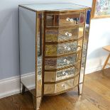 An Art Deco style mirrored Chest of six drawers, of flattened bow-front form, the top, sides, drawer