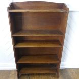 An early 20thC Liberty & Co oak Open Bookcase, with scalloped gallery back and shaped sides over