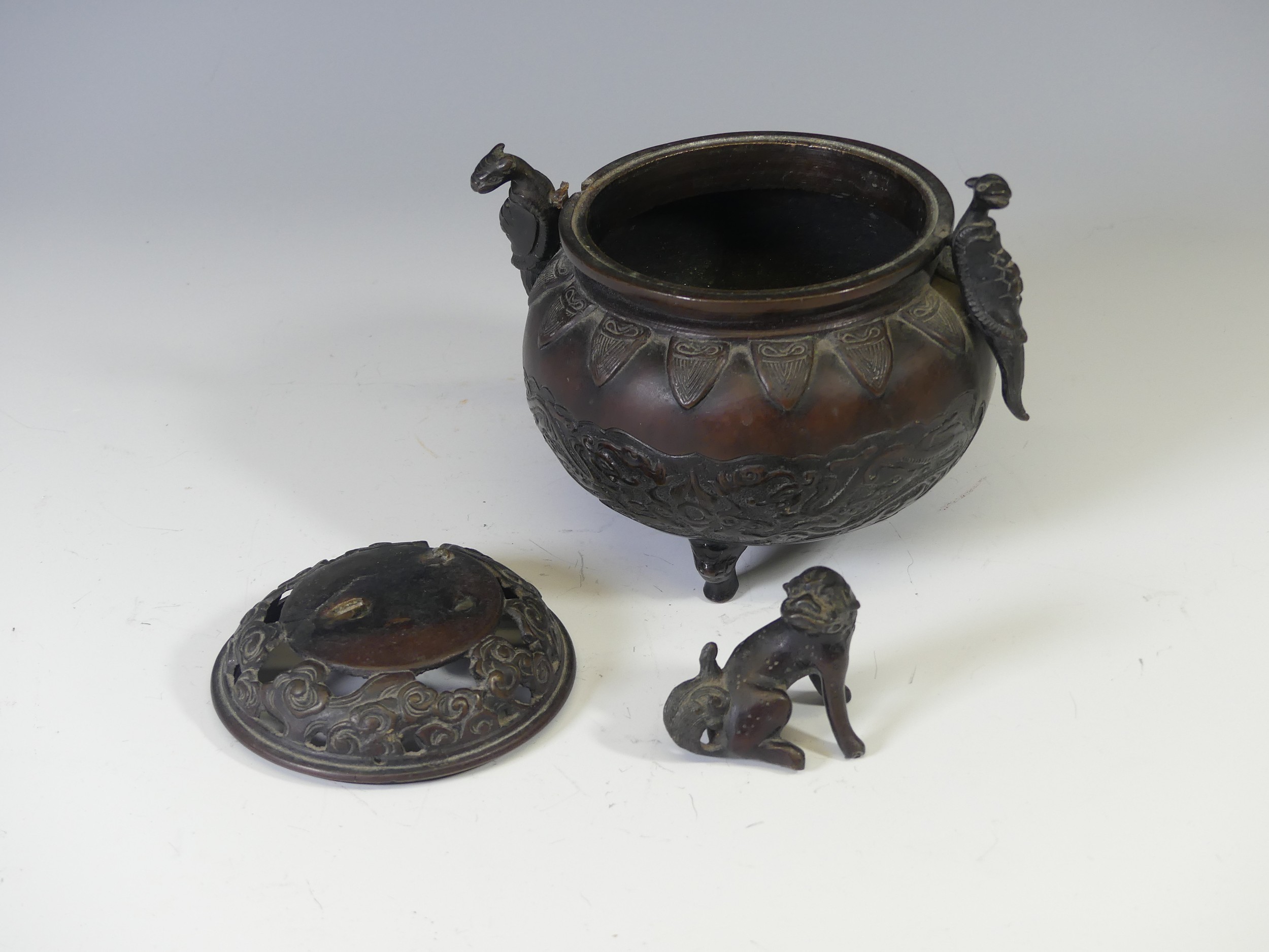 A 19th century oriental bronze twin-handle tripod Censer, with relief decoration depicting dragons - Image 2 of 6