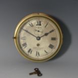 A vintage brass bulkhead Clock, the circular dial with black Roman numerals and subsidiary