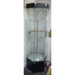 A hexagonal shop display Cabinet, with two spotlights and rotating circular shelves, H180cm x W