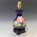 A Moorcroft 'Hibiscus' pattern Lamp Base, tubelined decoration on blue ground, on wooden base, H