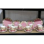 A Royal Worcester pink and gilt part Tea Service, comprising twelve Cups and Saucers, two Sugar