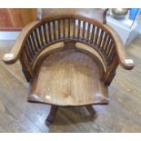 An early 20th century mahogany swivel Desk Chair, with spindle back and scroll arms.