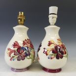 A pair of Moorcroft floral pattern Lamps, tubelined decoration on cream ground, factory marks to