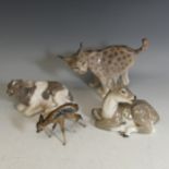 A Royal Copenhagen figure of a Cow, model 1072, 17cm wide, together with a recumbent fallow Deer,