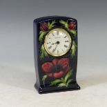 A Moorcroft 'Anenome' pattern Mantel Clock, tubelined decoration on blue ground, factory marks to