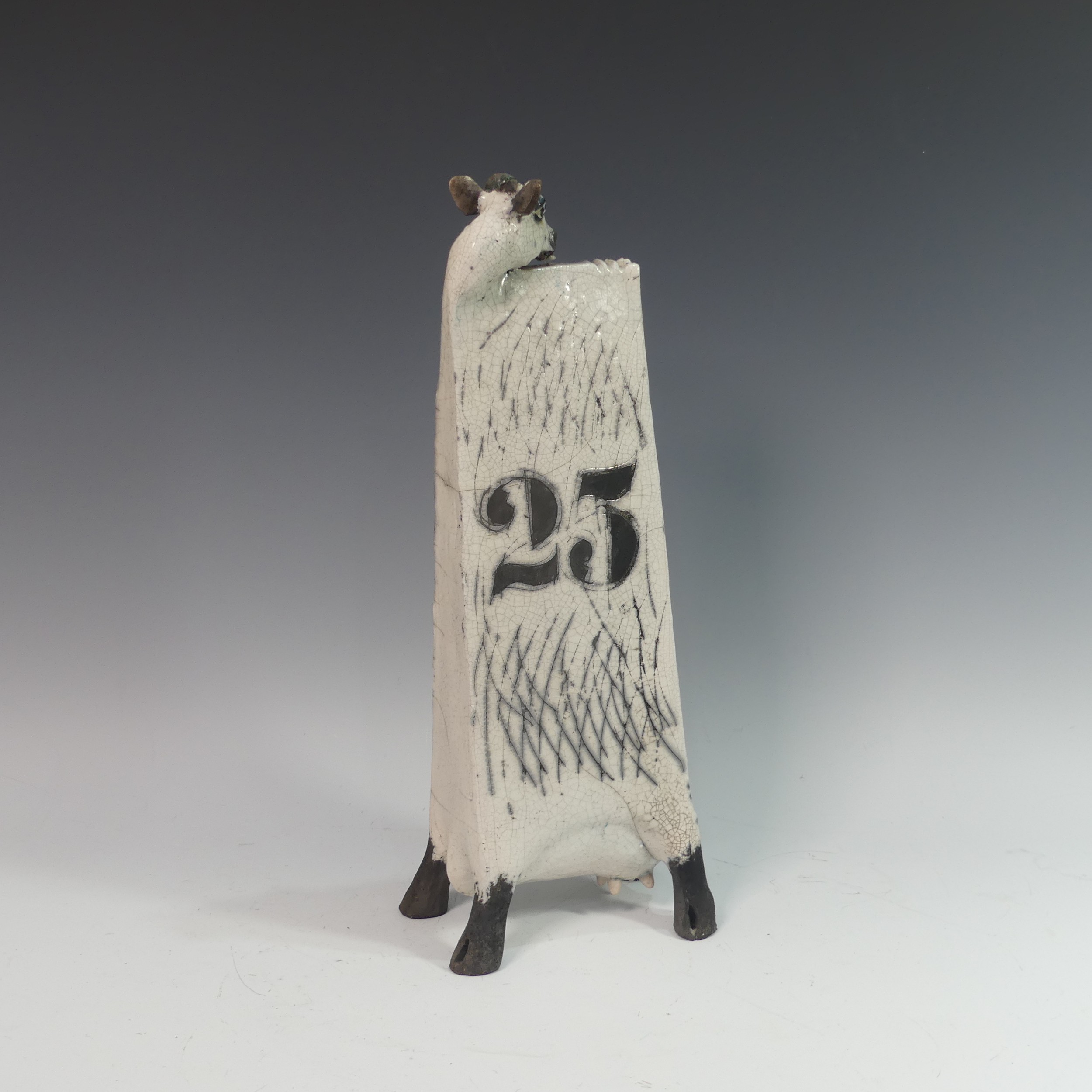 Lawson E. Rudge (b. 1936), a raku fired studio pottery sculpture of an elongated Cow, with chess - Image 2 of 3