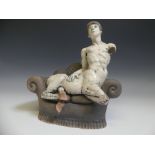 Lawson E. Rudge (b. 1936), a raku fired studio pottery sculpture of a Centaur on Sofa, H 31cm.