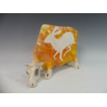 Lawson E. Rudge (b. 1936), a studio pottery sculpture of a Grazing Cow, with orange glazed hare
