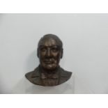 A bronzed terracotta bust of Winston Churchill, head and shoulders, H: 35.5cm x W: 35.5cm.