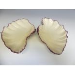 A pair of 18thC Wedgwood creamware shell shaped Dessert Dishes, with puce edging, one has a