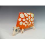 Lawson E. Rudge (b. 1936), a studio pottery sculpture of a Grazing Cow, with orange glazed spot