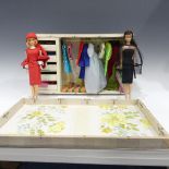 A Barbie doll and a Stacey doll with a selection of outfits,  many with labels including dresses