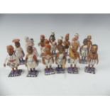 A collection of vintage Indian painted carved wood figures, in a variety of types and traditional