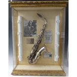 Charlie Parker interest; a display case containing a silver plate saxophone