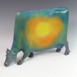 Lawson E. Rudge (b. 1936), a raku fired studio pottery sculpture of a Grazing Cow, with metallic