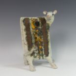 Lawson E. Rudge (b. 1936), a raku fired studio pottery sculpture of a Cow, numbered 525, H 34cm.