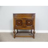 An early 20thC oak cased Selecta Gramophone, having a lift-up lid, record storage and door opening