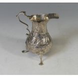 An early George III silver Cream Jug, hallmarked London 1766, makers mark unclear, of baluster