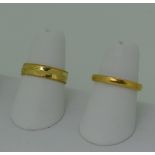 A 22ct yellow gold Band, 2.65mm wide, Size L, 4.5g, together with an 18ct gold band, with engraved