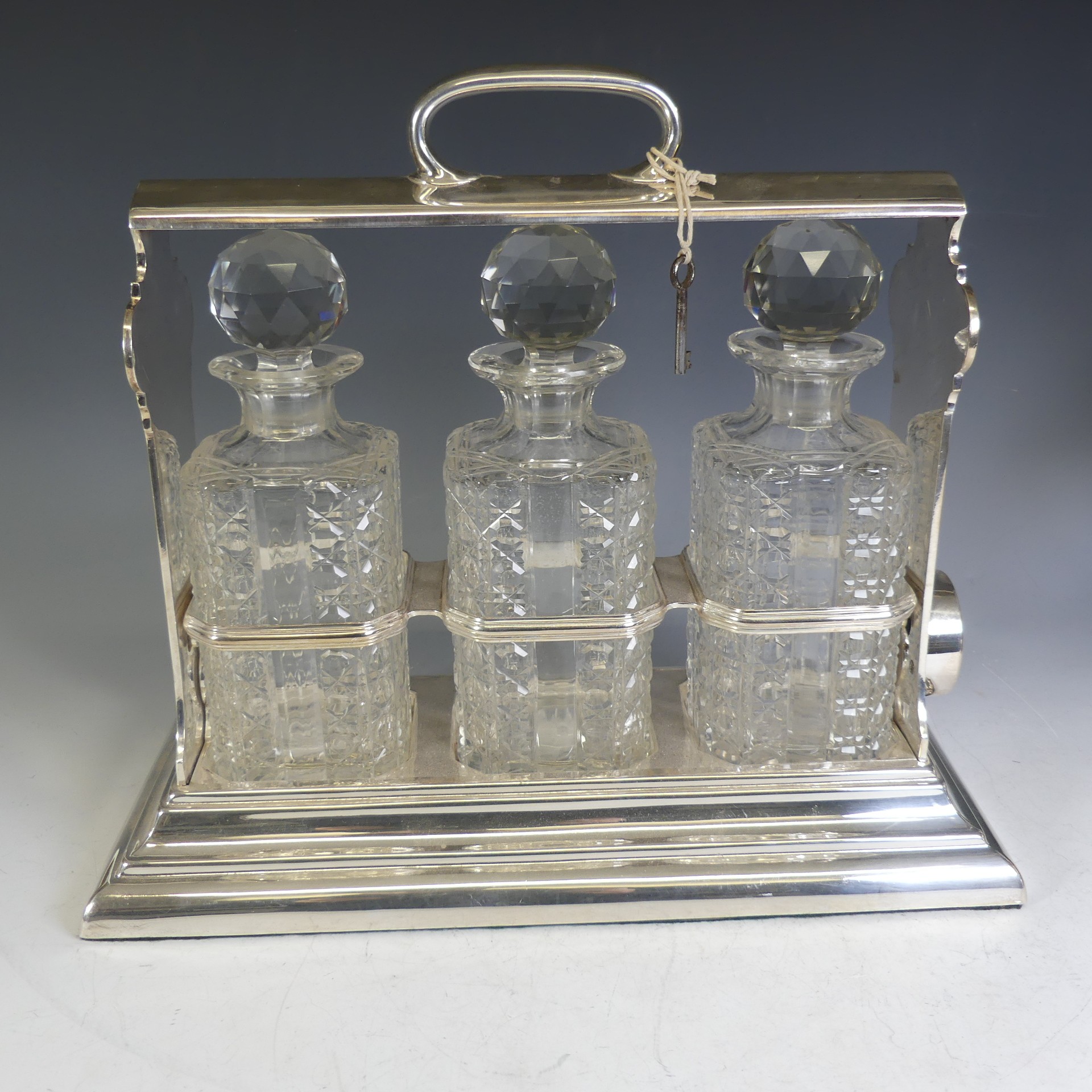 A silver-plated Walker & Hall Tantalus, encasing three cut glass decanters, in a locking " - Image 4 of 5