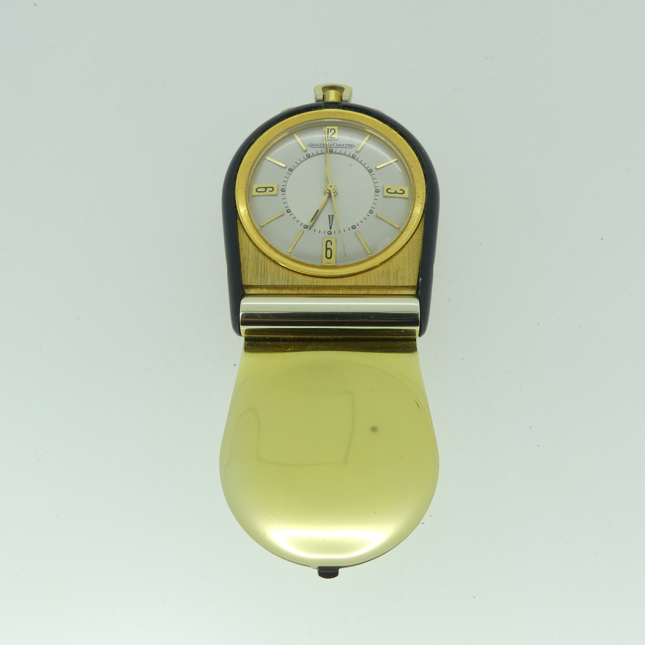 A Jaeger-LeCoultre travelling Alarm Clock, manual wind, the silvered dial with Arabic numerals and