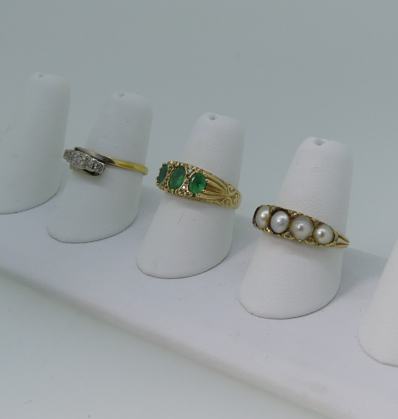 A three stone emerald Ring, mounted in 9ct yellow gold, Size M, 3.1g, together with a small five