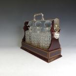 An Edwardian mahogany Tantalus, marked "The Tantalus", with inlaid decoration and silver-plated