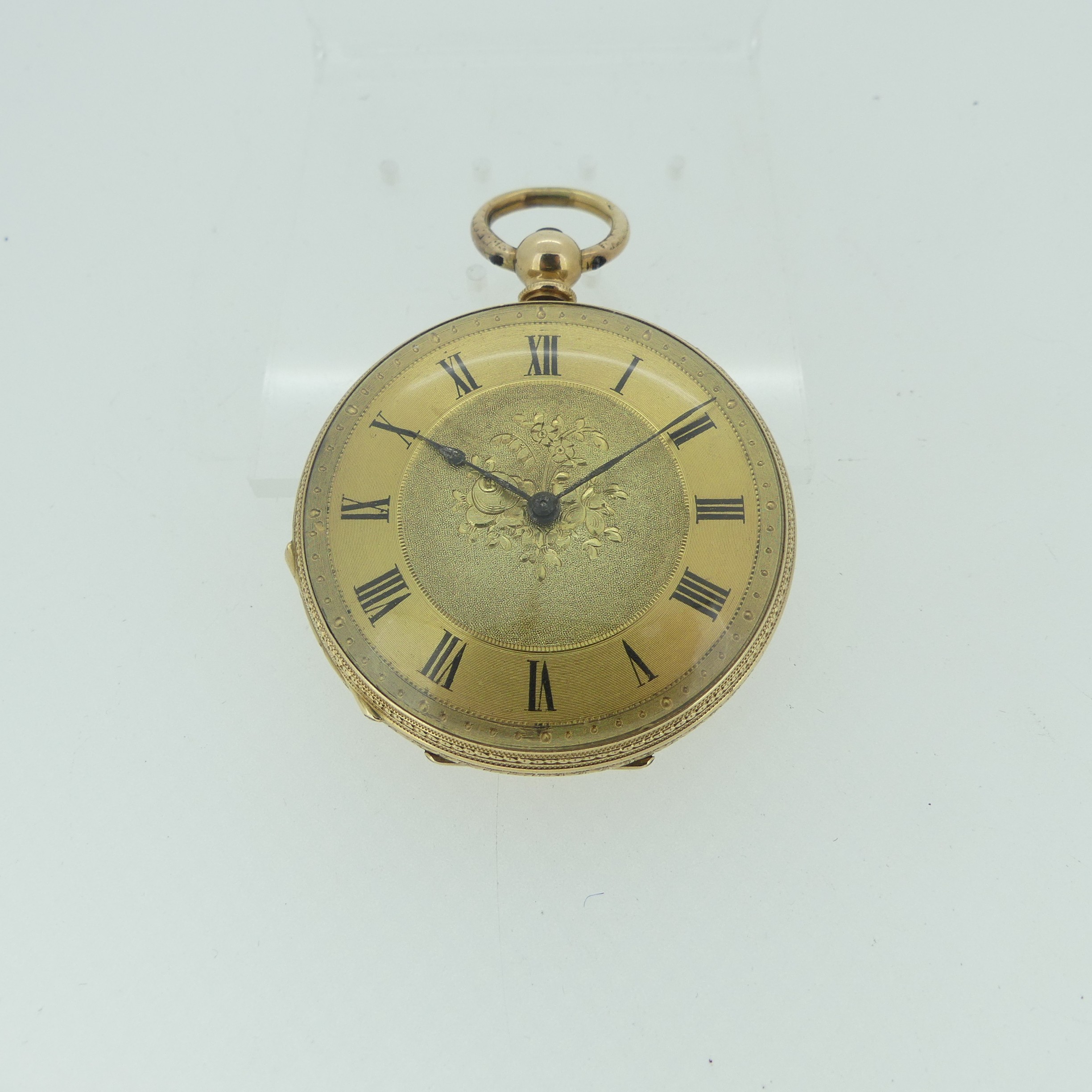 A pretty continental 14k gold open face Pocket Watch, key wound, with foliate engraved decoration