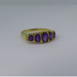 A graduated five stone amethyst Ring, the oval facetted stones mounted in 18ct yellow gold, Size