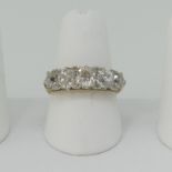 A graduated five stone diamond Ring, the old cut stones claw set in a carved gallery, the shank