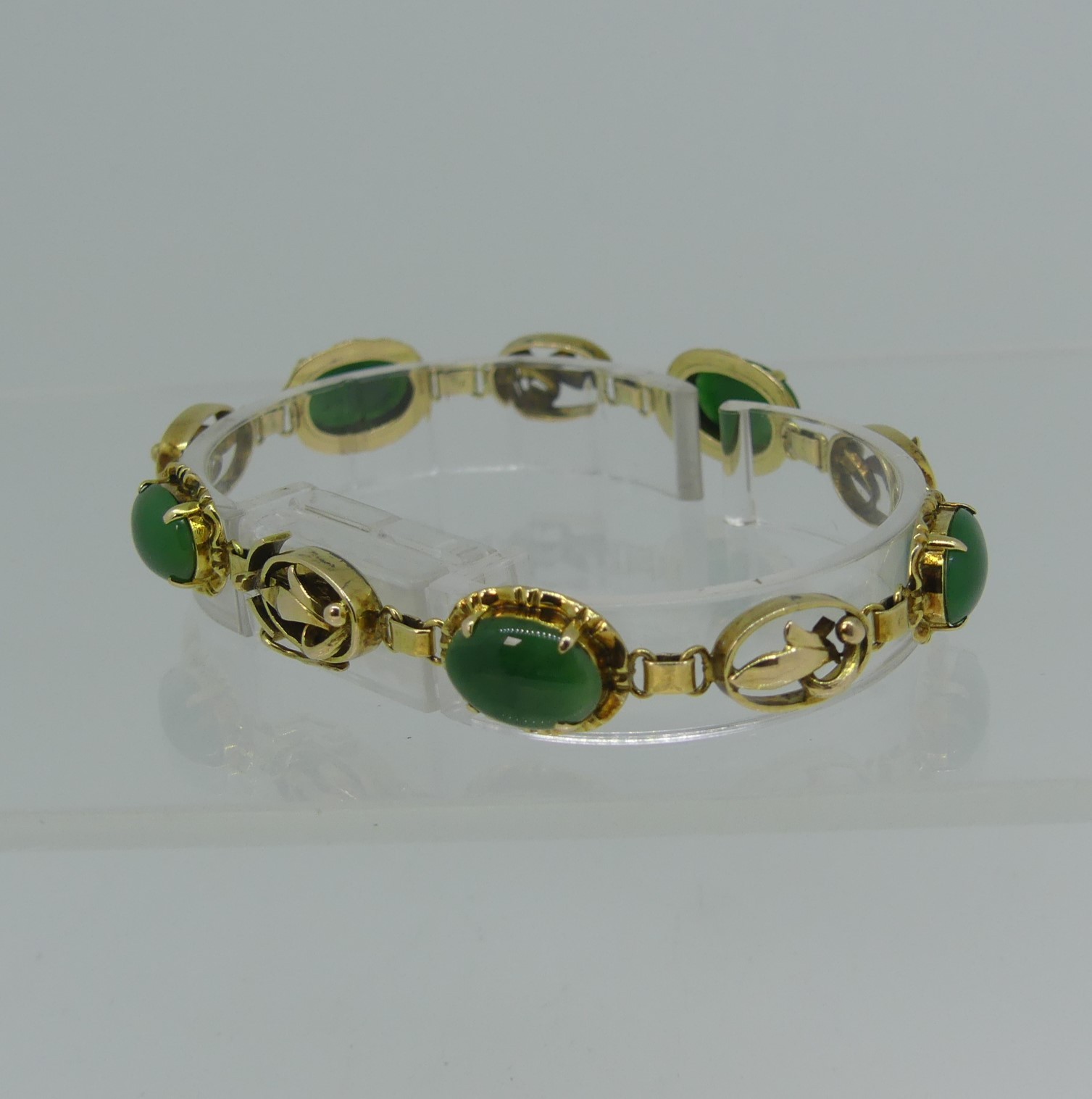 A 14ct yellow gold Bracelet, set with five oval cabochon jades, the integral clasp marked 14k and - Image 2 of 3