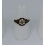 A Victorian 18ct gold and black enamel Mourning Ring, the circular front set with a seed pearl