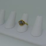 A star sapphire and diamond Ring, the cabochon pale sapphire approx. 6.5mm diameter collet set in