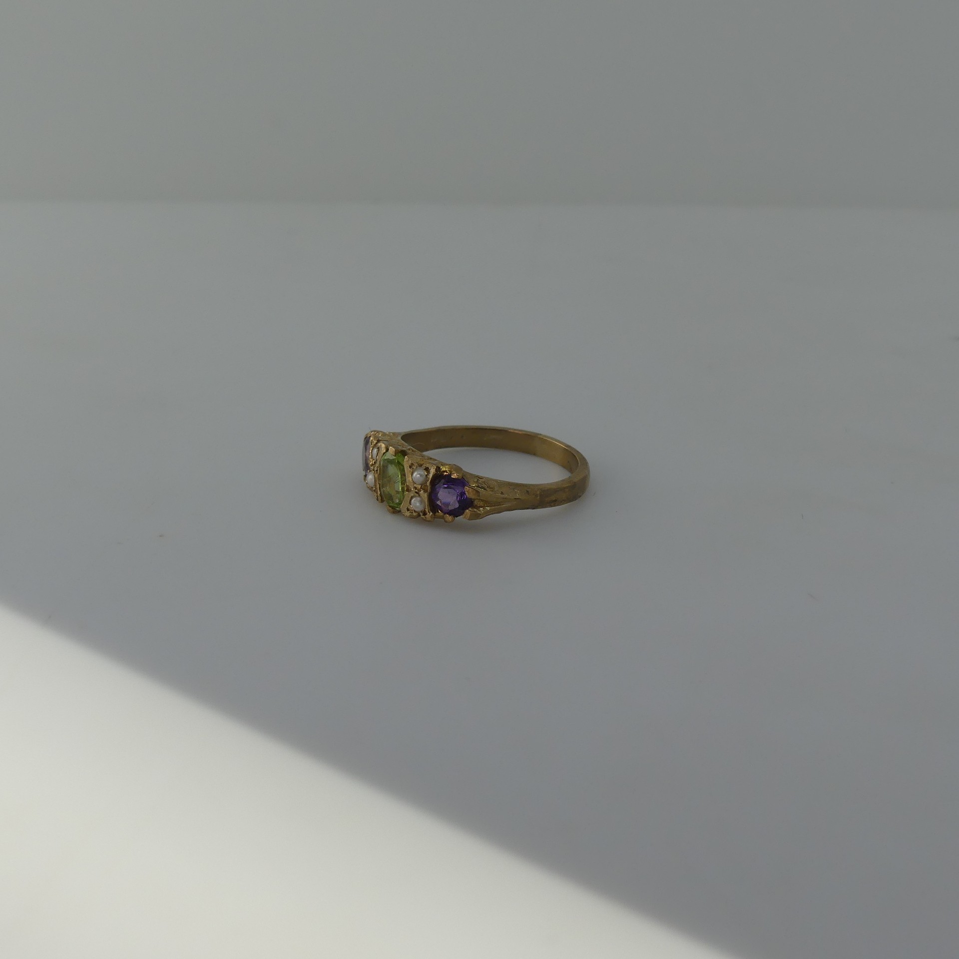 A Suffragette style three stone Ring, the central oval peridot with a circular amethyst on either - Image 3 of 4