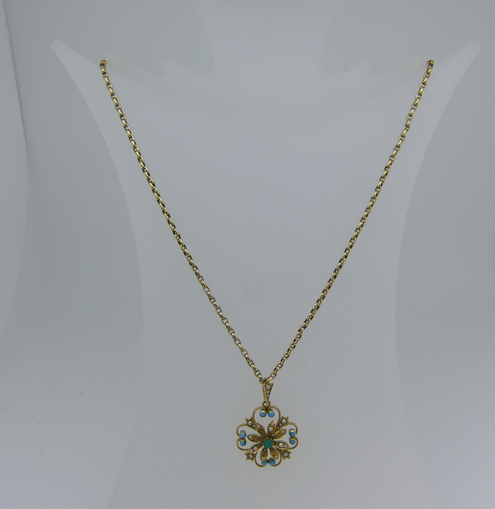 An antique turquoise and seed pearl Pendant, of open foliate form, with seed pearl set suspension