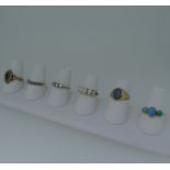 Six 9ct gold Rings; variously set including a three stone turquoise, unmarked but tested, opal,