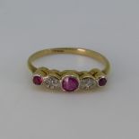 A small ruby and diamond five stone Ring, the central ruby with an illusion set diamond on either