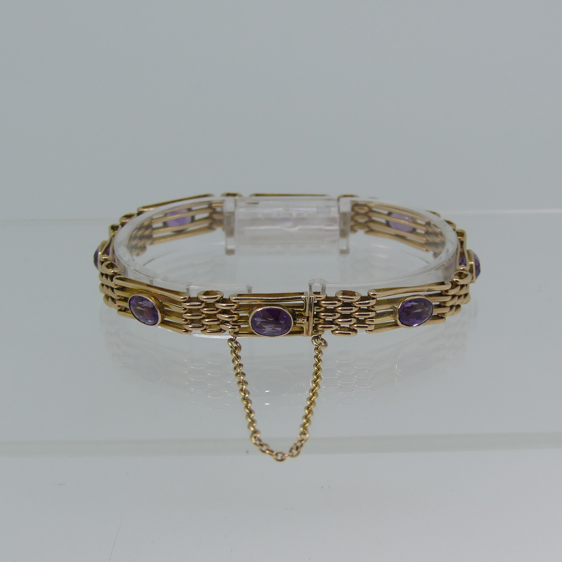 A 9ct yellow gold gatelink Bracelet, set with eight facetted amethysts, one link forming the - Image 4 of 4