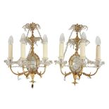 A SET OF FOUR GILT AND MIRRORED THREE LIGHT SCONCES