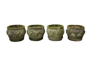 A SET OF FOUR RECONSTITUTED STONE GARDEN PLANTERS